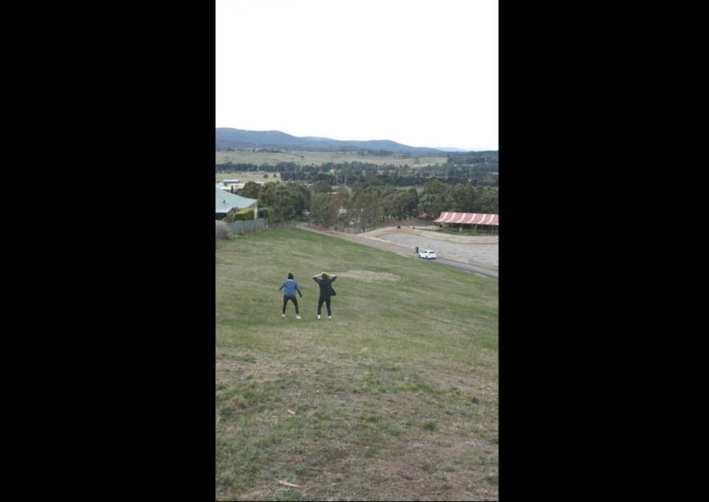 Image about Guy Rolls Down Hill in Tire Towards Car, Video