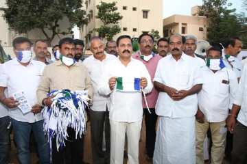 Image about YSRCP People Distributing Masks Carrying Party Flags