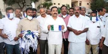 Image about YSRCP People Distributing Masks Carrying Party Flags